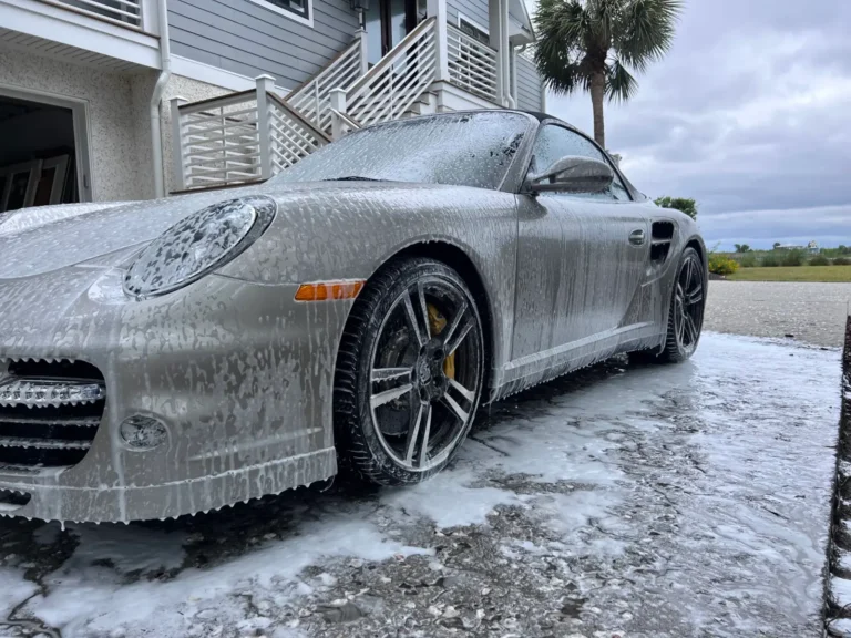 Porsche 911 covered in foam during a wash