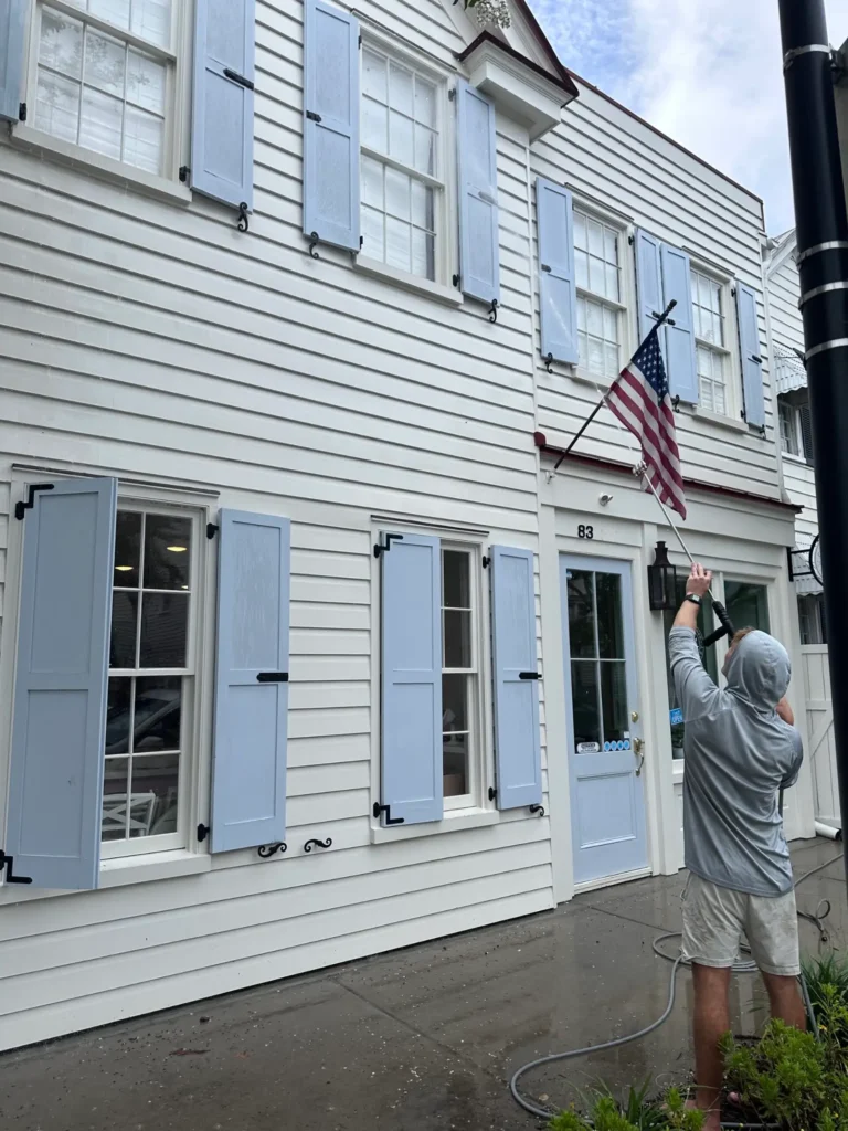 Pressure washing (soft wash) a white Charleston home